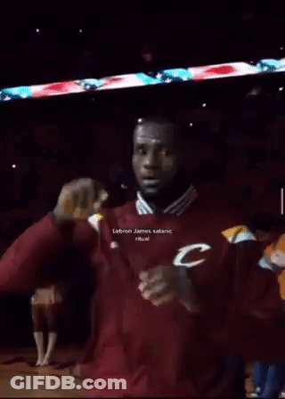 A Man In A Maroon Adidas Jacket Stands In Front Of A Sign That Says 666 GIF