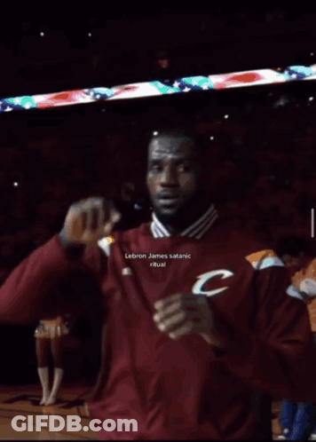 A Man In A Maroon Adidas Shirt Is Making A 666 Sign GIF