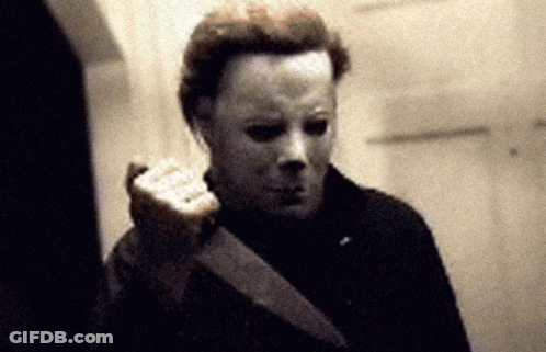 A Man In A Mask Holds A Knife In His Hand GIF