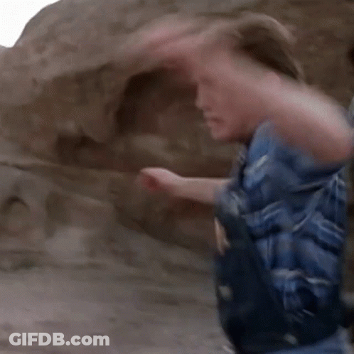 A Man In A Mask Is Being Punched In The Face GIF
