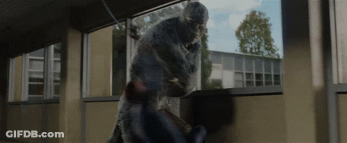 A Man In A Mask Is Fighting Another Man In A Room GIF