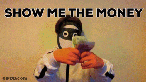 A Man In A Mask Is Holding A Bunch Of Money In Front Of His Face With The Words Show Me The Money Behind Him GIF