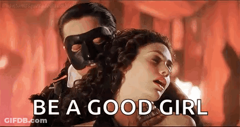 A Man In A Mask Is Holding A Woman In A Room And Says `` Be A Good Girl '' . GIF