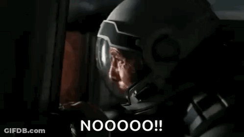 A Man In A Mask Is Looking At A Computer Screen And Saying Nooooo ! GIF