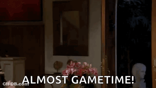 A Man In A Mask Is Peeking Out Of A Door With The Words Almost Gametime Below Him GIF