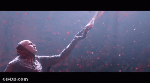 A Man In A Mask Is Reaching Up Towards The Sky GIF