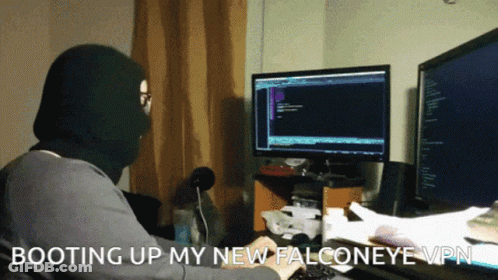 A Man In A Mask Is Typing On A Keyboard With The Words Booting Up My New Falconeye Vpn GIF
