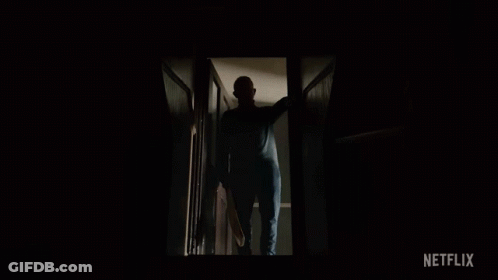 A Man In A Mask Is Walking Down The Stairs With A Netflix Logo In The Corner GIF