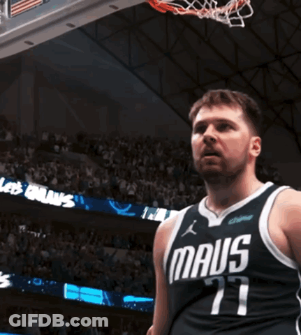 A Man In A Maus Jersey Stands In Front Of A Basketball Hoop GIF