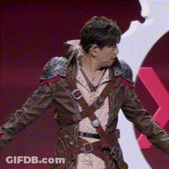 A Man In A Medieval Costume Is Standing With His Arms Outstretched In Front Of A Red Background . GIF