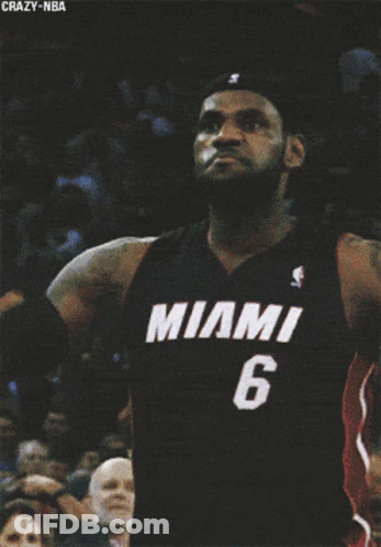 A Man In A Miami 6 Jersey Is Dancing In Front Of A Crowd GIF