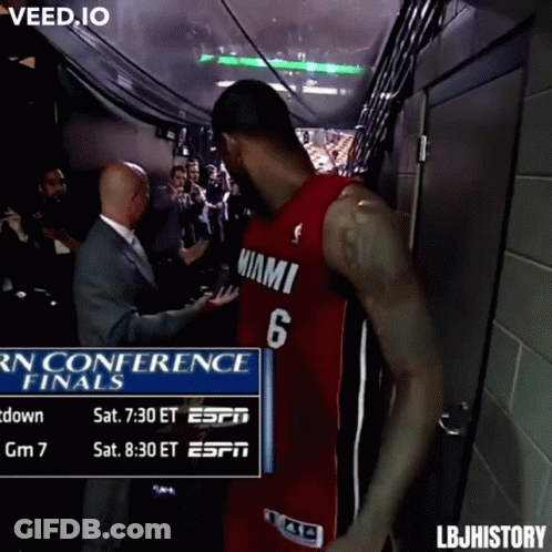 A Man In A Miami Jersey Is Standing In A Hallway GIF