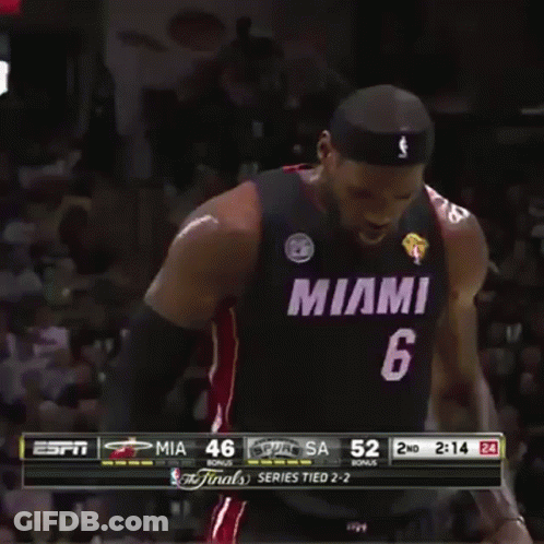 A Man In A Miami Jersey Stands In Front Of A Crowd During A Game GIF