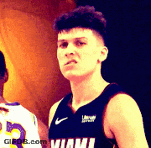 A Man In A Miami Jersey Stands Next To Another Player GIF