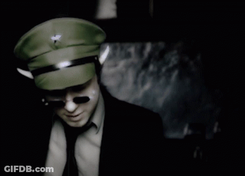 A Man In A Military Hat And Sunglasses Stands In Front Of A Sign That Says Do You Know What That Means GIF