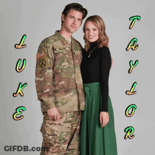 A Man In A Military Uniform And A Woman In A Green Skirt Are Posing For A Picture GIF