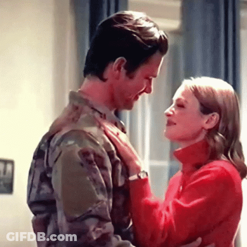 Man In Military Uniform Hugging Woman In Red GIF