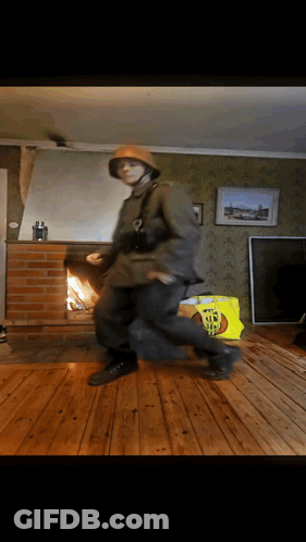 A Man In A Military Uniform Dancing In A Living Room GIF