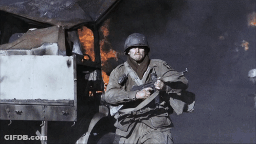 A Man In A Military Uniform Holding A Gun With The Letters U.s.a. On It GIF