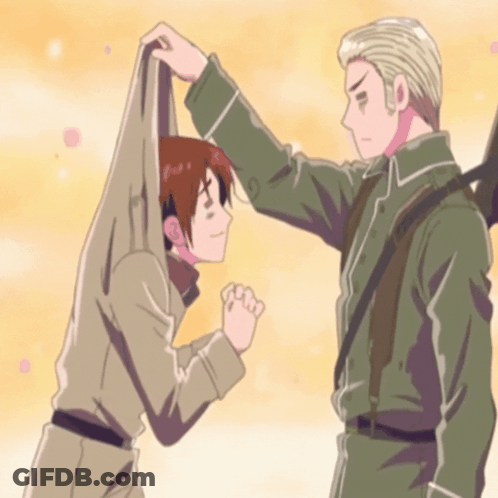 A Man In A Military Uniform Holds Another Man 'S Arm GIF