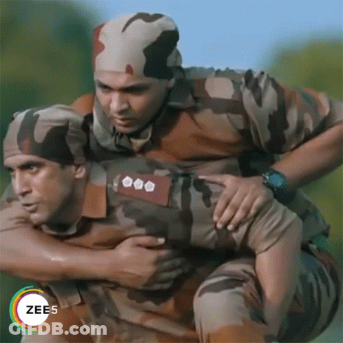 A Man In A Military Uniform Is Carrying Another Man On His Shoulders GIF
