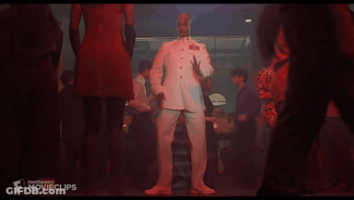 A Man In A Military Uniform Is Dancing In A Club GIF