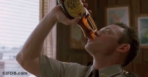 A Man In A Military Uniform Is Drinking A Bottle Of Pure Taste GIF