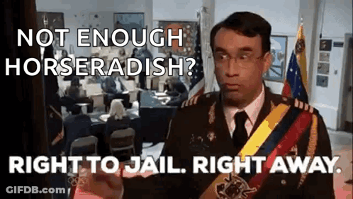 A Man In A Military Uniform Is Giving A Speech In Front Of A Group Of People . GIF