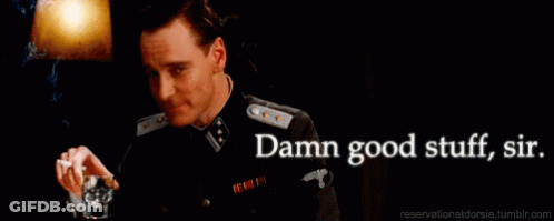 A Man In A Military Uniform Is Holding A Glass And Smoking A Cigarette GIF