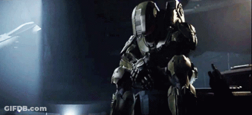 A Man In A Military Uniform Is Holding A Gun And Talking On A Radio GIF