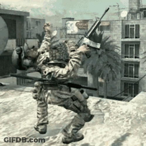 A Man In A Military Uniform Is Holding A Gun In Front Of A Palm Tree GIF