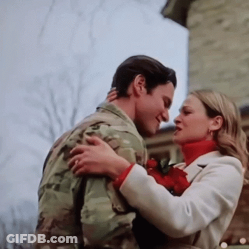 Man In Military Uniform Hugging Woman In White Coat GIF
