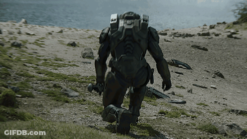 A Man In A Military Uniform Is Kneeling In The Dirt GIF