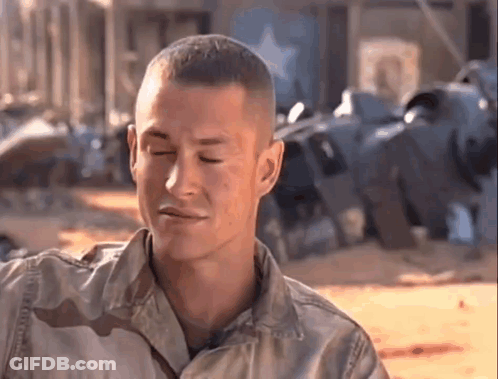 A Man In A Military Uniform Is Making A Funny Face . GIF