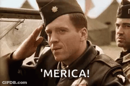 A Man In A Military Uniform Is Saluting While Another Man Says ' Merica ' . GIF