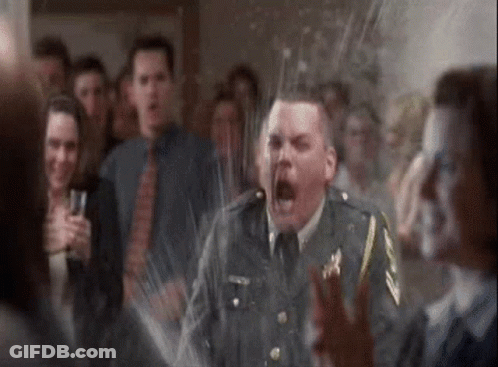 A Man In A Military Uniform Is Screaming In Front Of A Crowd Of People At A Party . GIF