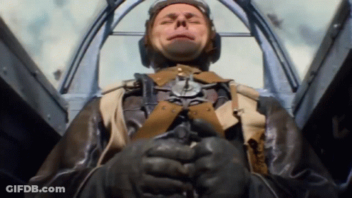A Man In A Military Uniform Is Sitting In A Cockpit GIF