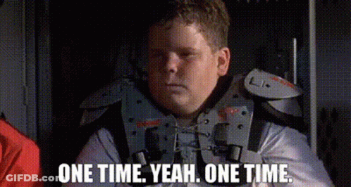 A Man In A Military Uniform Is Sitting In A Dark Room With The Words `` One Time Yeah , One Time . '' GIF