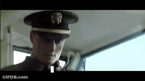 A Man In A Military Uniform Is Sitting In The Back Seat Of A Car . GIF