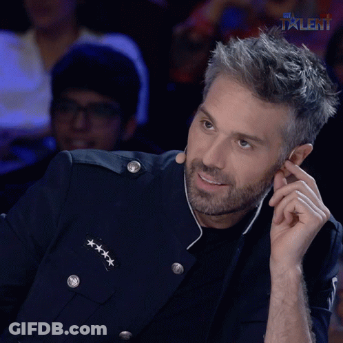 A Man In A Military Uniform Is Smiling And Talking On A Cell Phone In Front Of A Talent Logo GIF