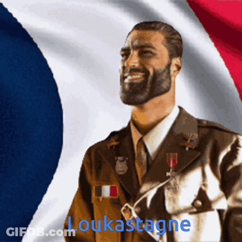 A Man In A Military Uniform Is Smiling In Front Of A French Flag And The Name Loukastagne Is Visible GIF