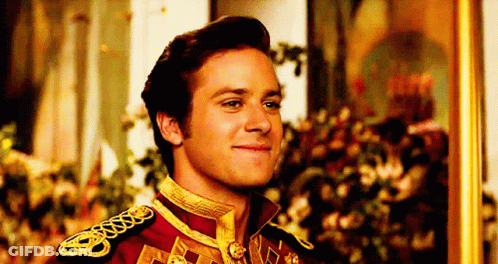 A Man In A Military Uniform Is Smiling In Front Of A Painting . GIF