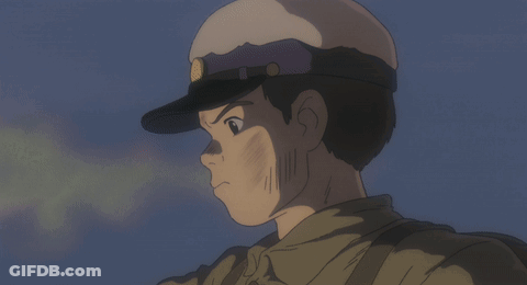 A Man In A Military Uniform Is Smiling With His Tongue Out GIF