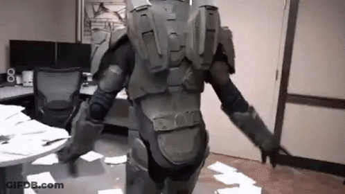 A Man In A Military Uniform Is Standing In A Room With A Lot Of Papers On The Floor . GIF