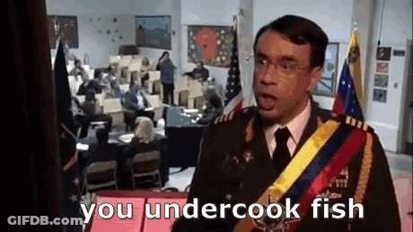 A Man In A Military Uniform Is Standing In Front Of A Crowd Of People And Talking To Them . GIF
