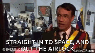 A Man In A Military Uniform Is Standing In Front Of A Crowd Of People In A Room . GIF
