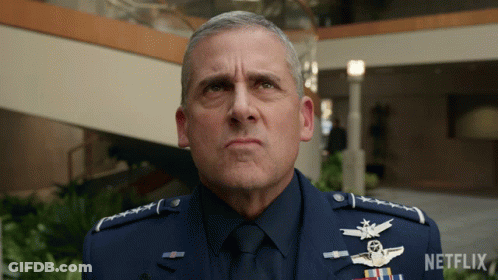 A Man In A Military Uniform Is Standing In Front Of A Netflix Sign GIF