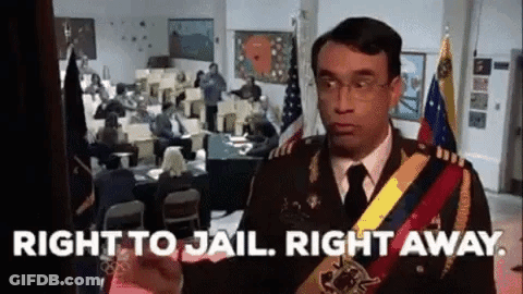 A Man In A Military Uniform Is Standing In Front Of A Room With People Sitting At Desks . GIF