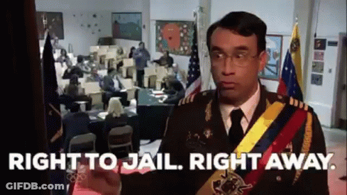 A Man In A Military Uniform Is Standing In Front Of A Room With People Sitting At Tables . GIF