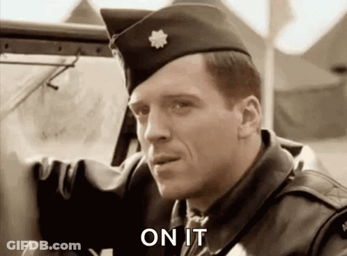 A Man In A Military Uniform Is Standing Next To A Car And Saying On It . GIF